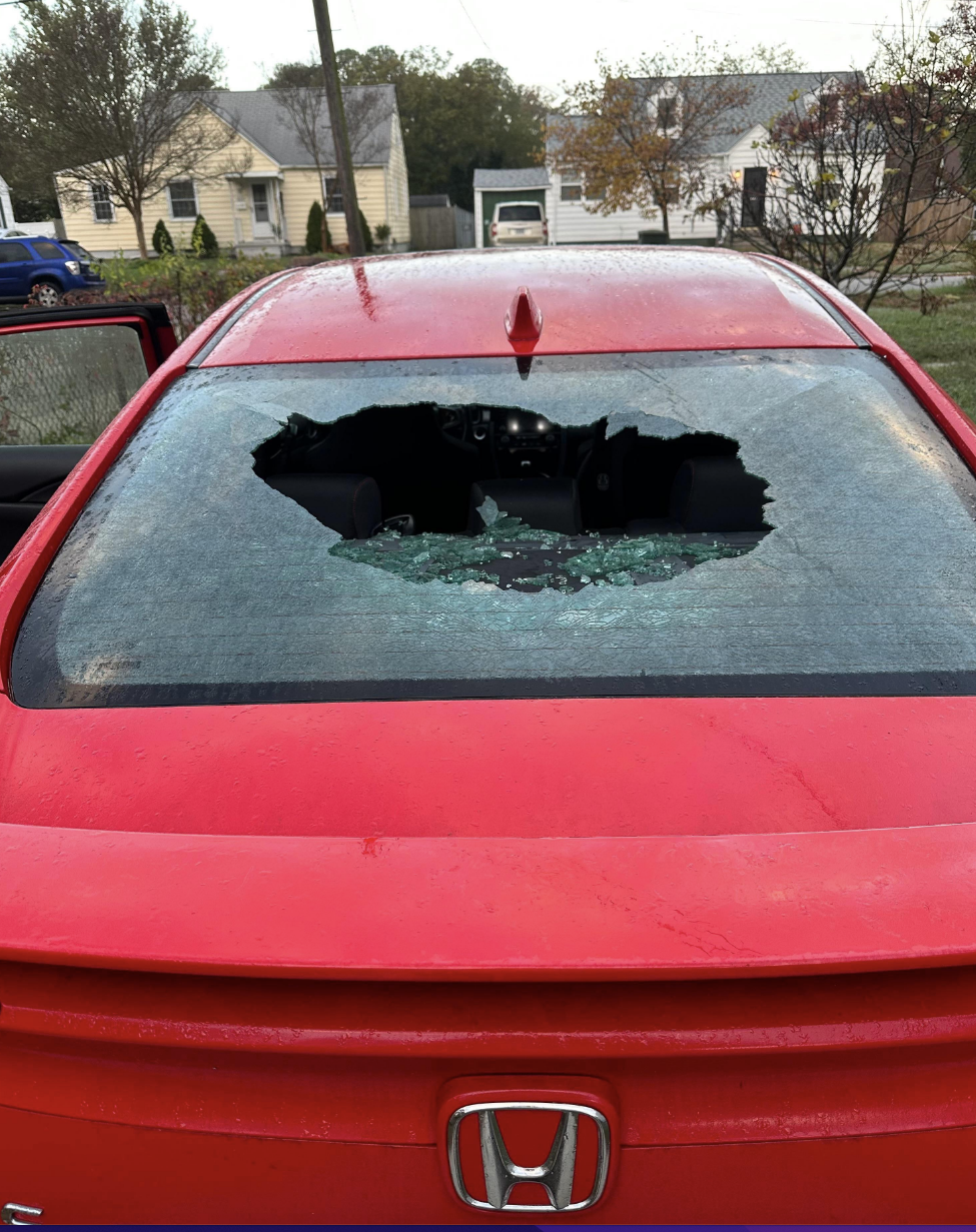 The rear window of their car is smashed in the middle