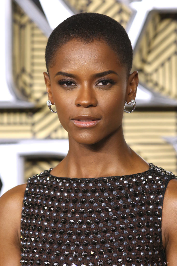 Letitia with a close-cropped hairdo and beaded sleeveless top