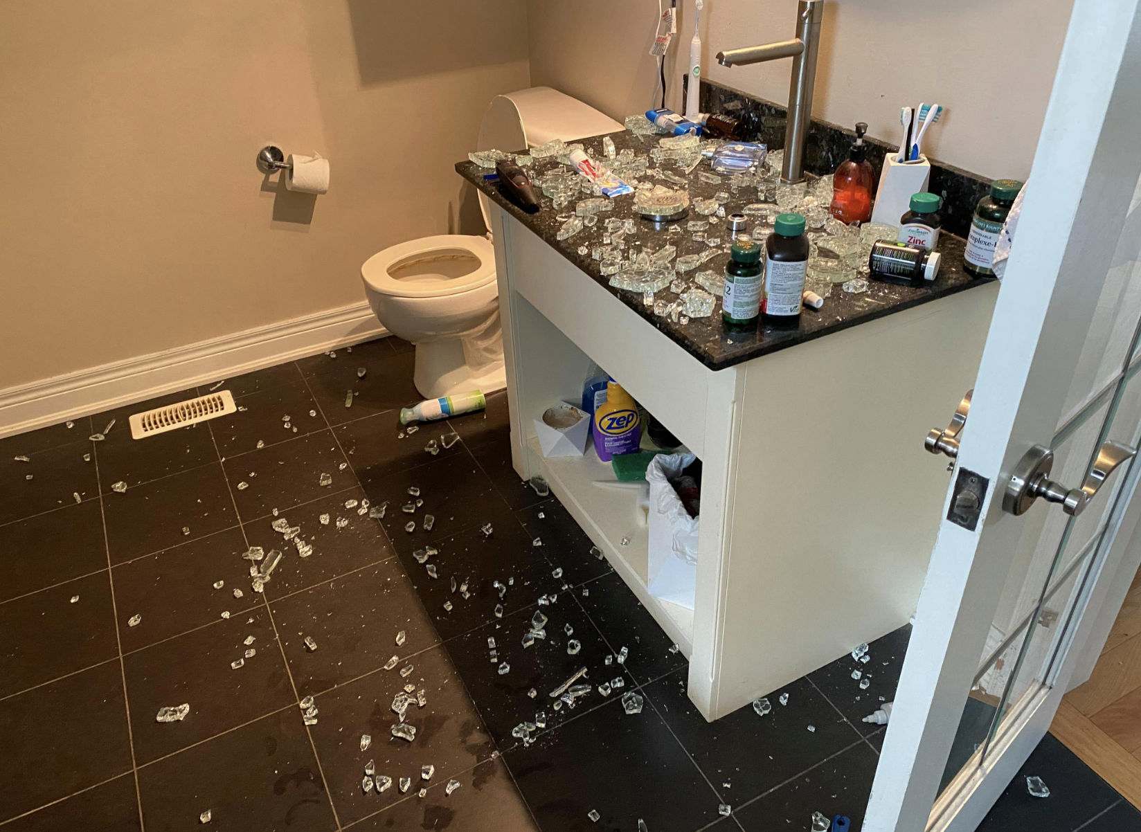 Someone dropped their cologne onto a glass sink, shattering both and covering the bathroom in shards of glass