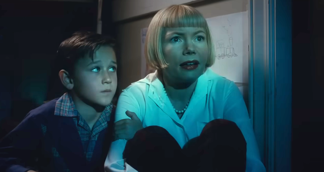 Michelle Williams as Mitzi looks wonderstruck as her son looks at her