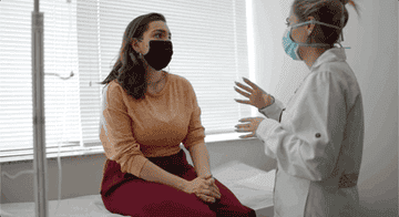 A doctor speaking to her patient