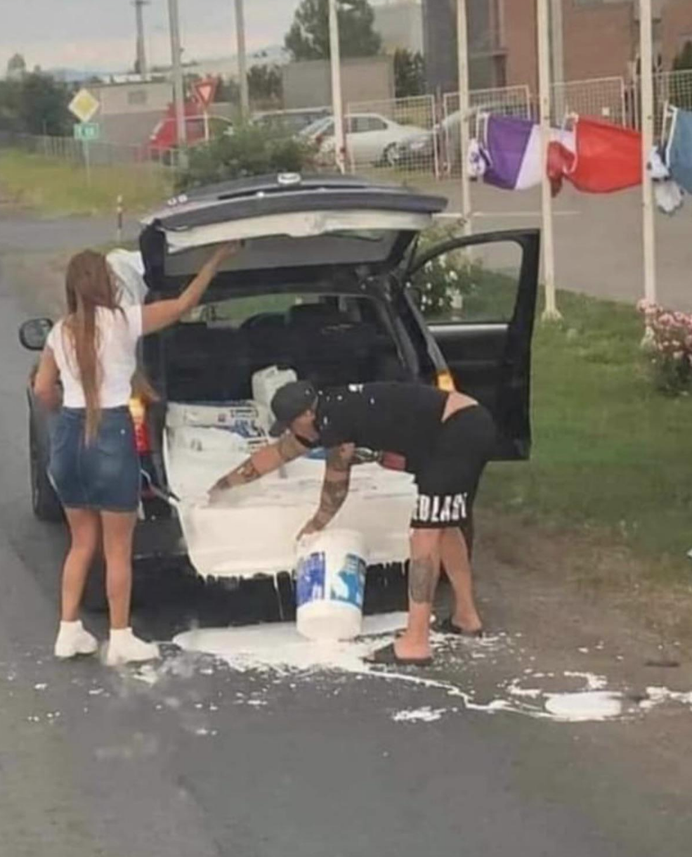 A huge tub of paint spilled in someone&#x27;s trunk, and they&#x27;re using their hands to try to scrape the paint back into the bucket