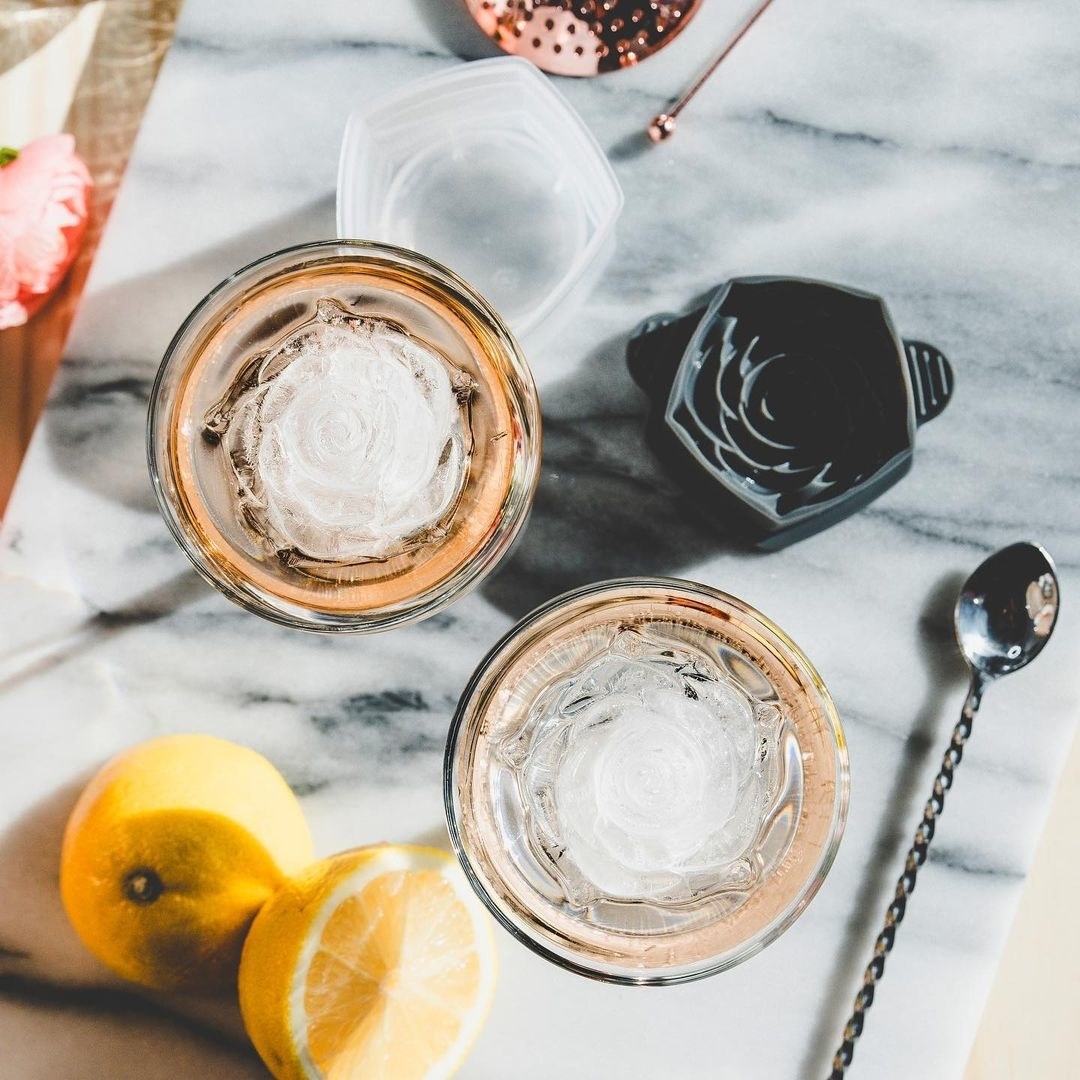 a top down view of the rose shaped ice inside cocktail glasses