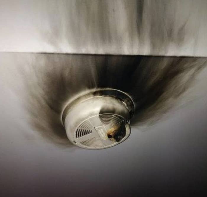 A charred circle surrounds a smoke detector on the ceiling