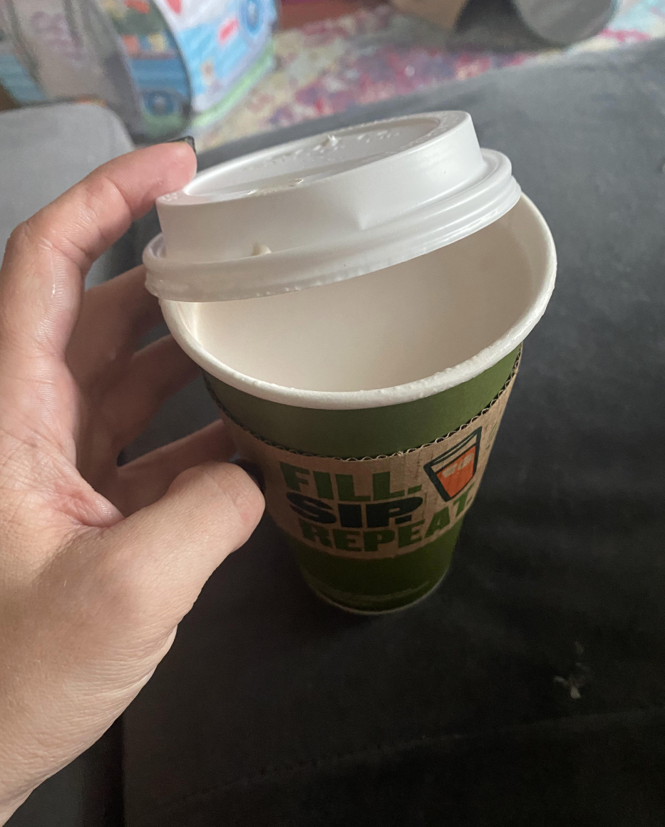 A hot chocolate cup that appears to simply be full of milk