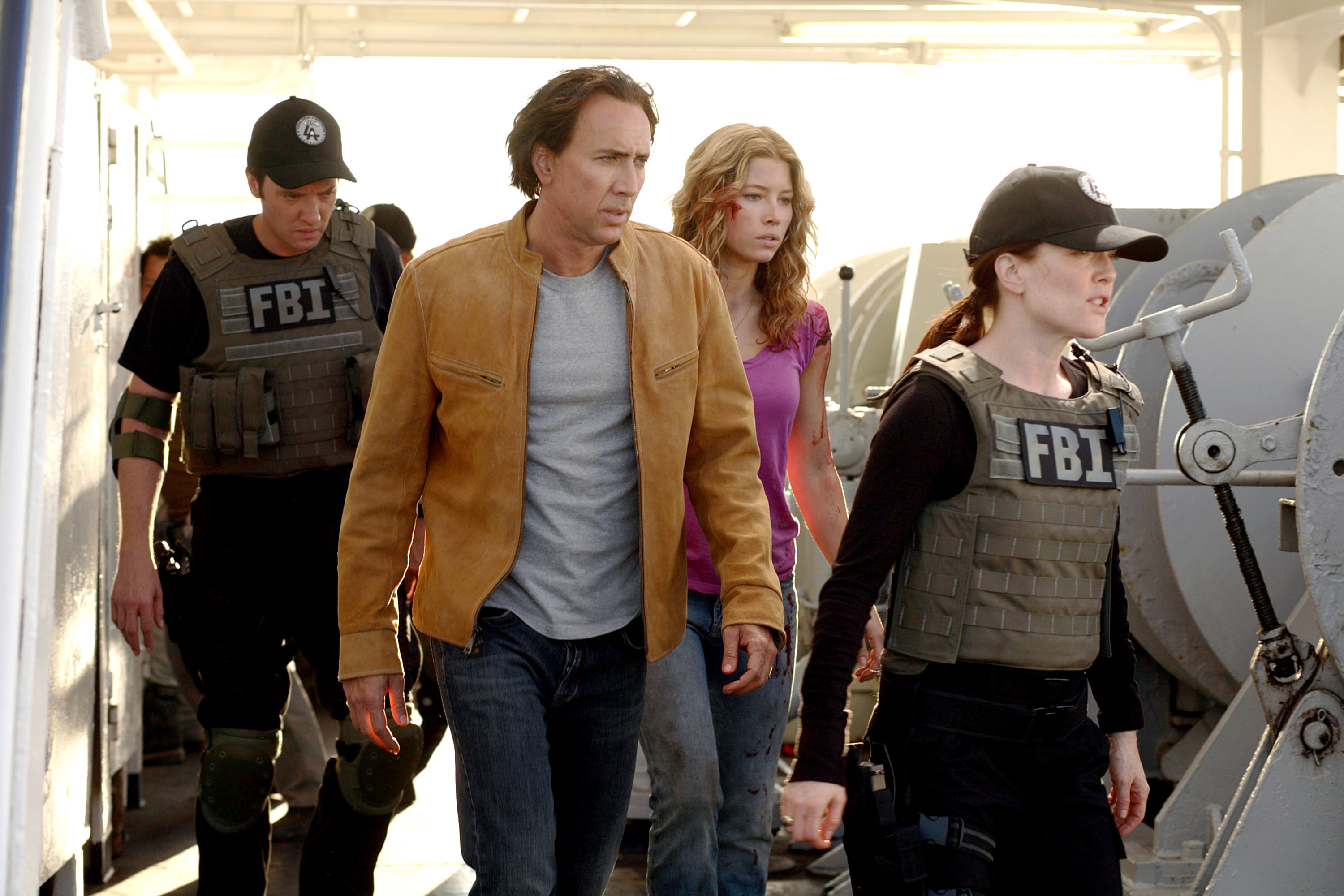 Four people, including two wearing FBI vests, walking