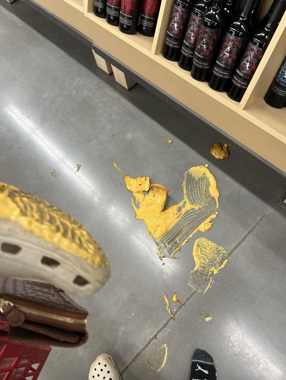 Queso-covered footprints in an aisle of a grocery store