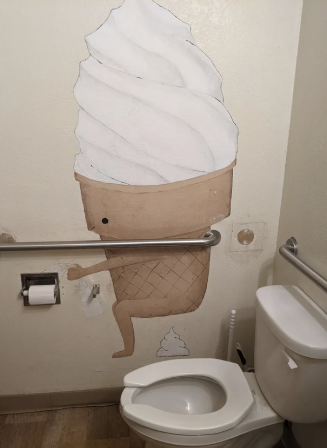 A cone pooping cream on a wall