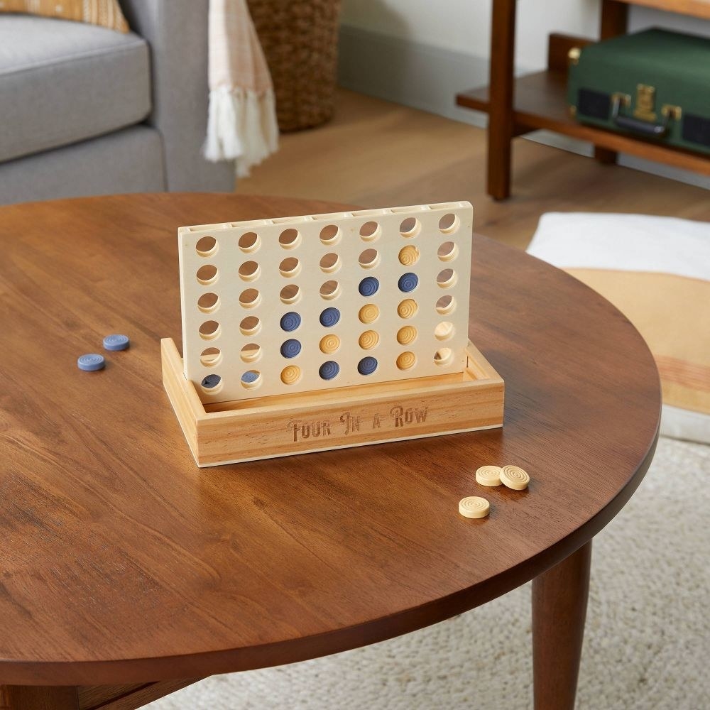 the four in a row game set up on a table