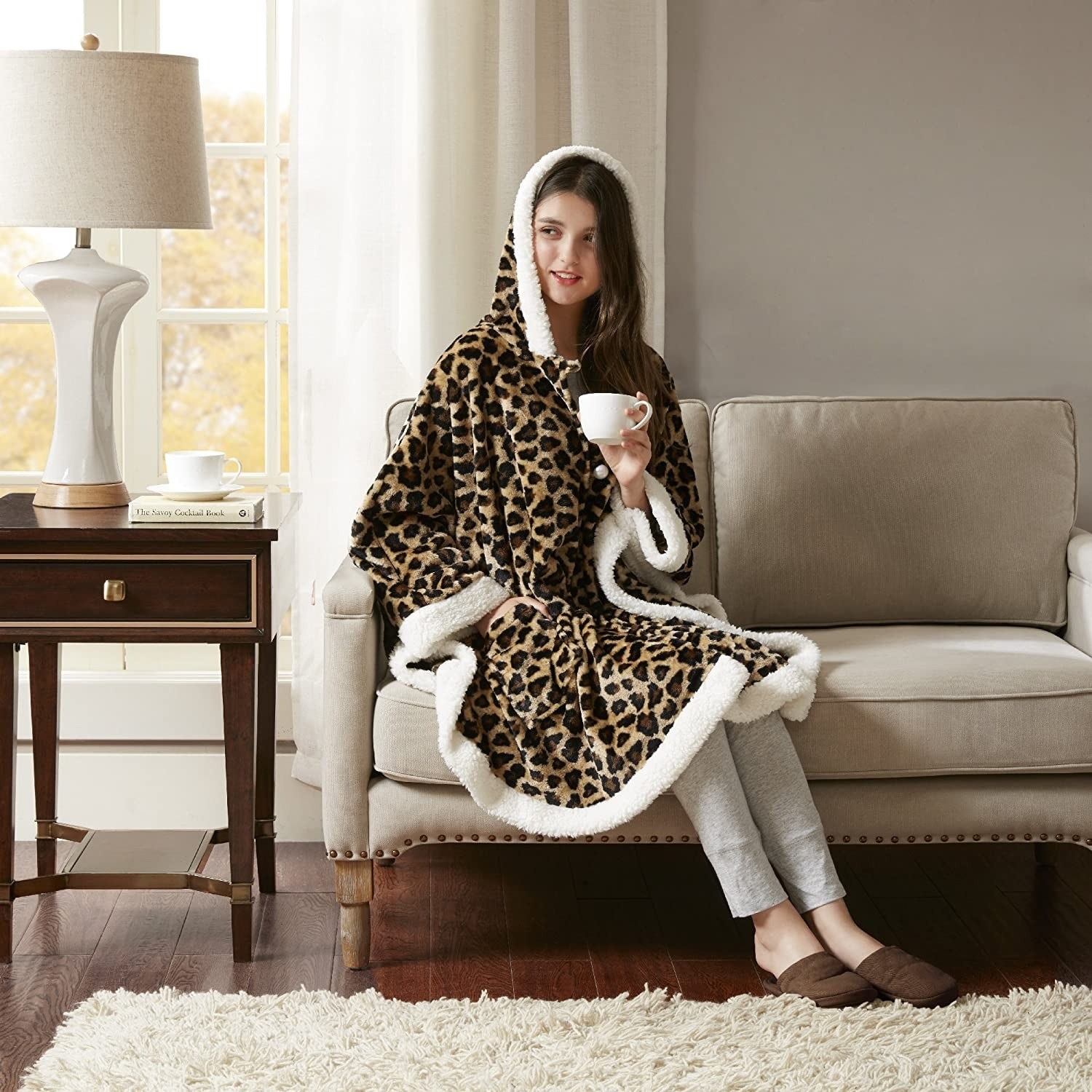 a model wearing the leopard print blanket shawl