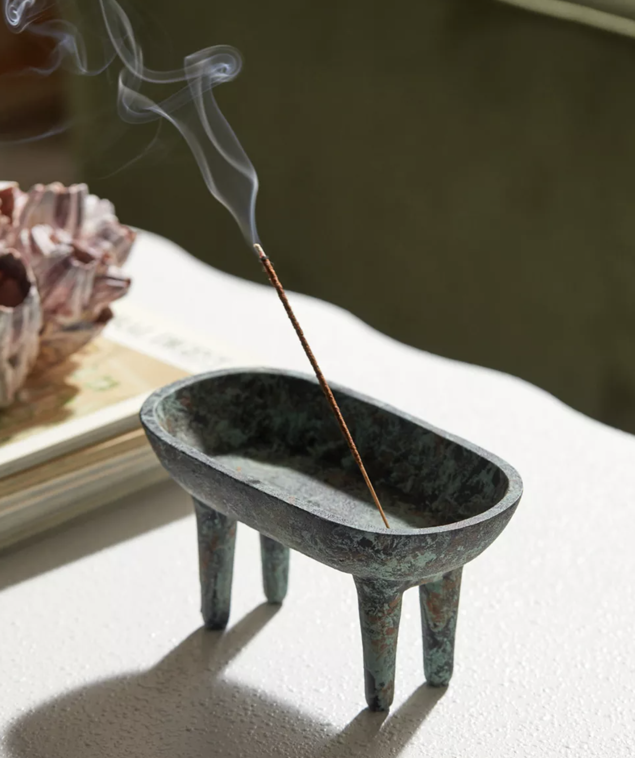 The incense holder with a stick of incense in it