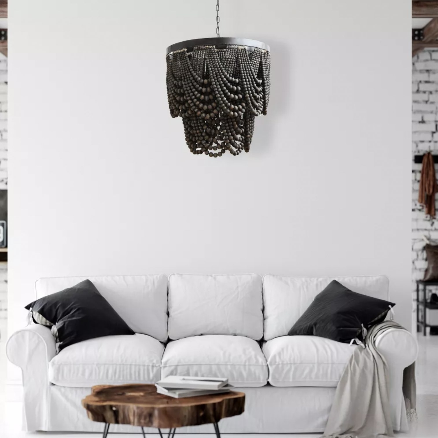 the chandelier hanging above white couch