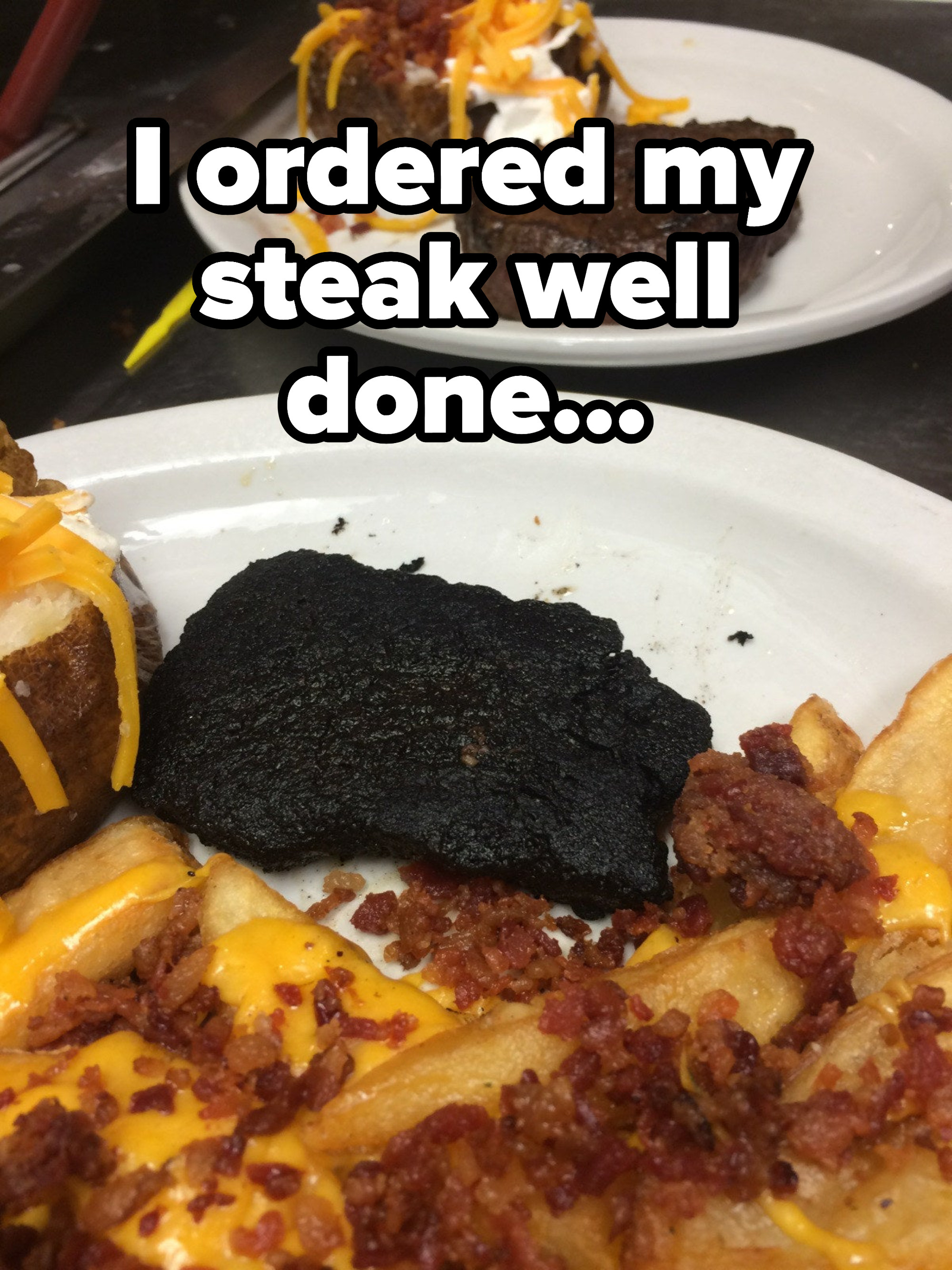 A burnt piece of thin meat alongside cheese on toast and bacon bits