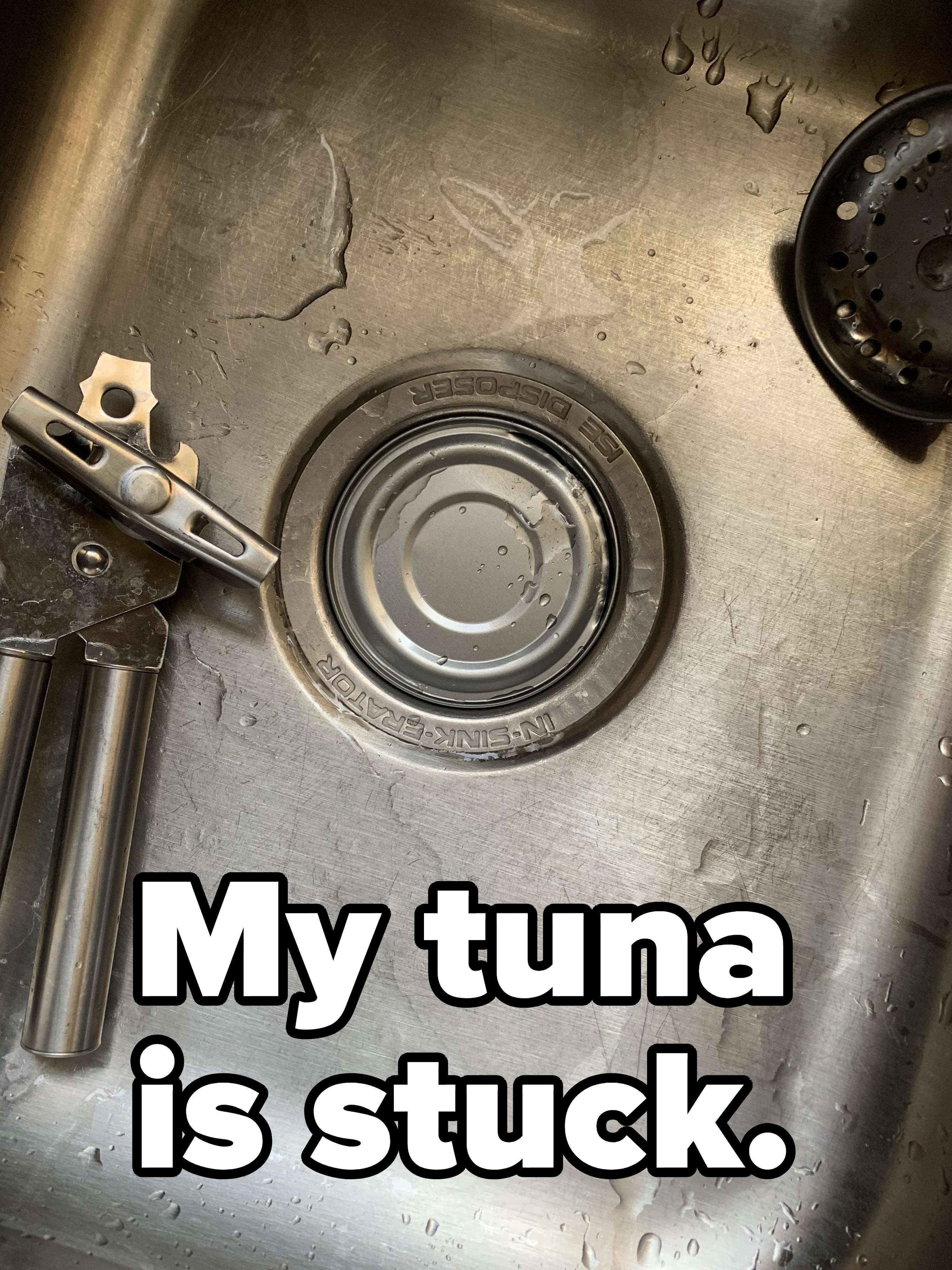 The top of a tuna can perfectly stuck in a sink drain