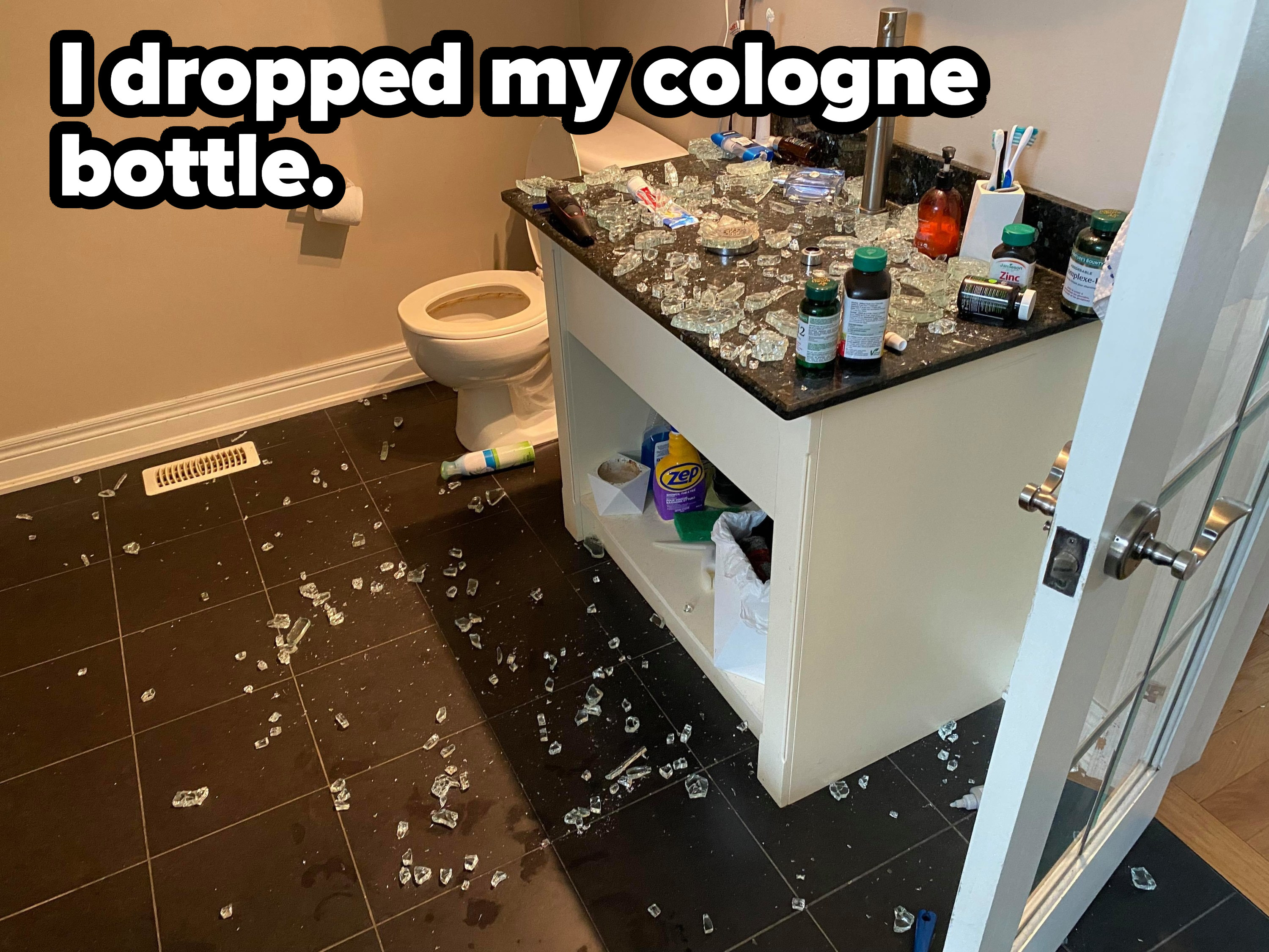 Pieces of glass all over a bathroom counter and the tiled floor