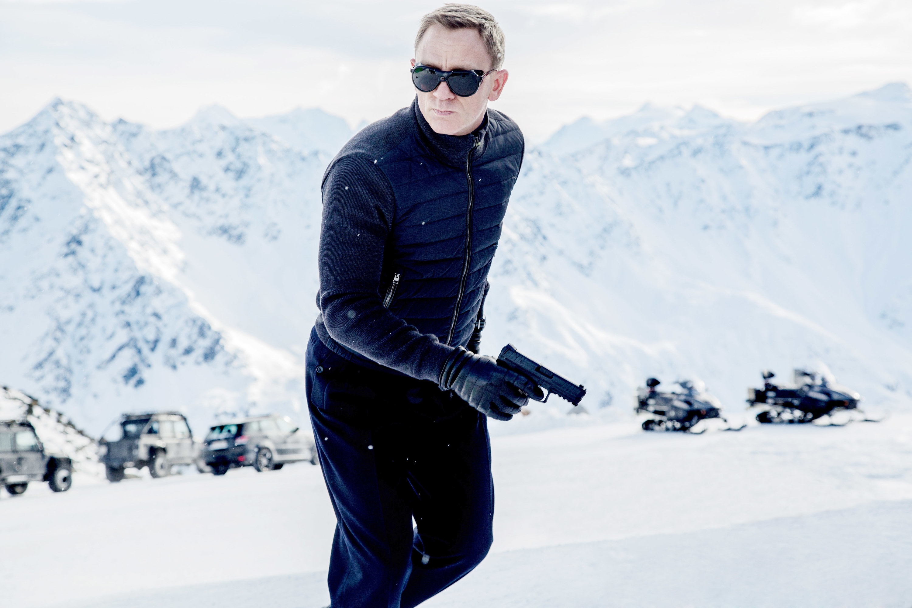 A man in a snowy landscape running with a gun