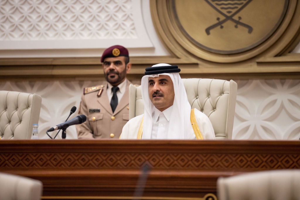 Emir Sheik Tamim bin Hamad Al Thani sitting at a podium