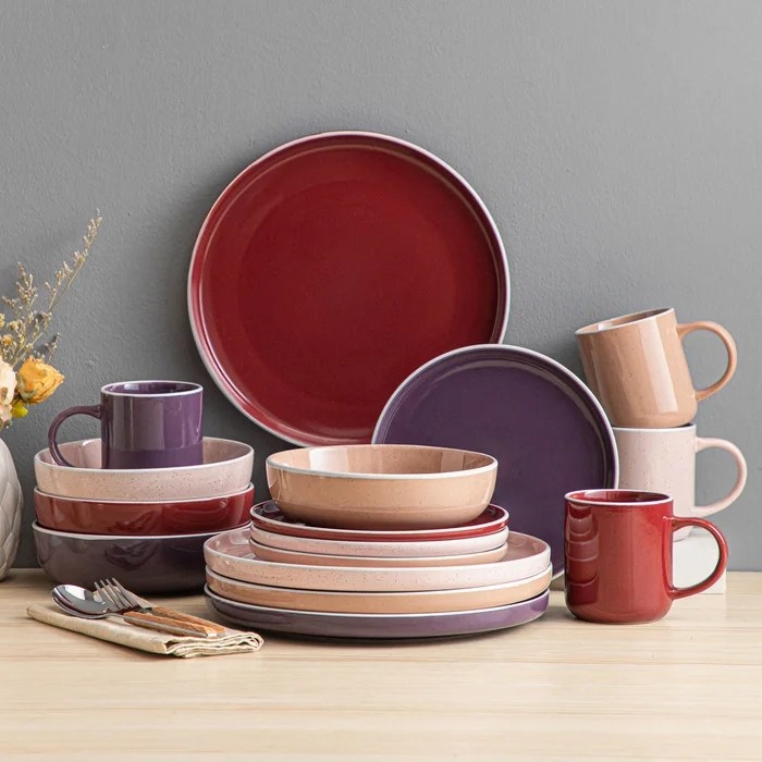 Colorful dinnerware set with plates, mugs and bowls