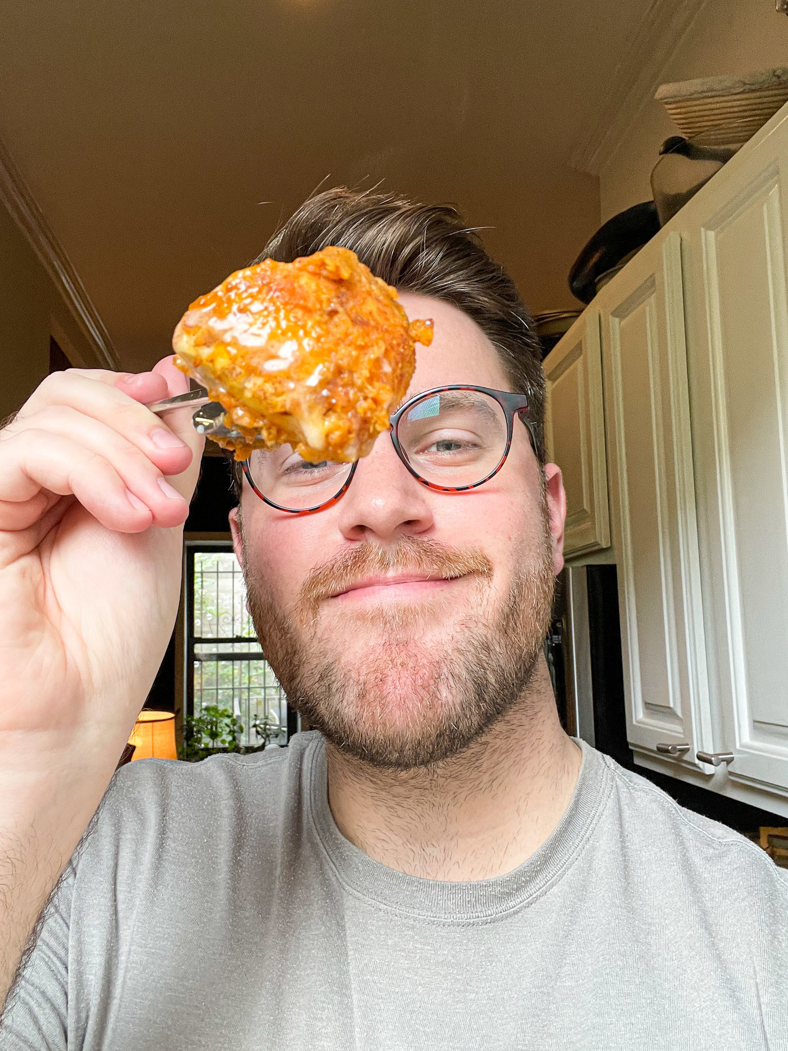 author holding up a bite of the cinnamon rolls