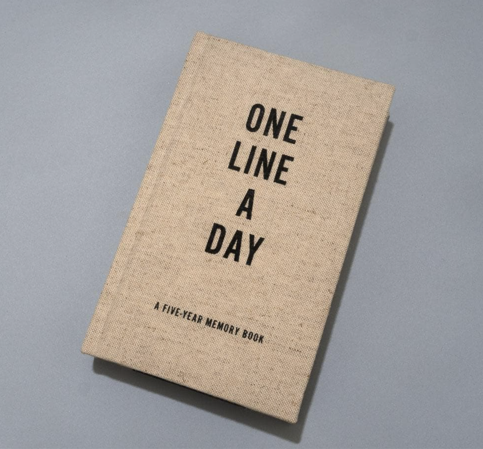 a bunch of versions of the one line a day journal lined up beside each other
