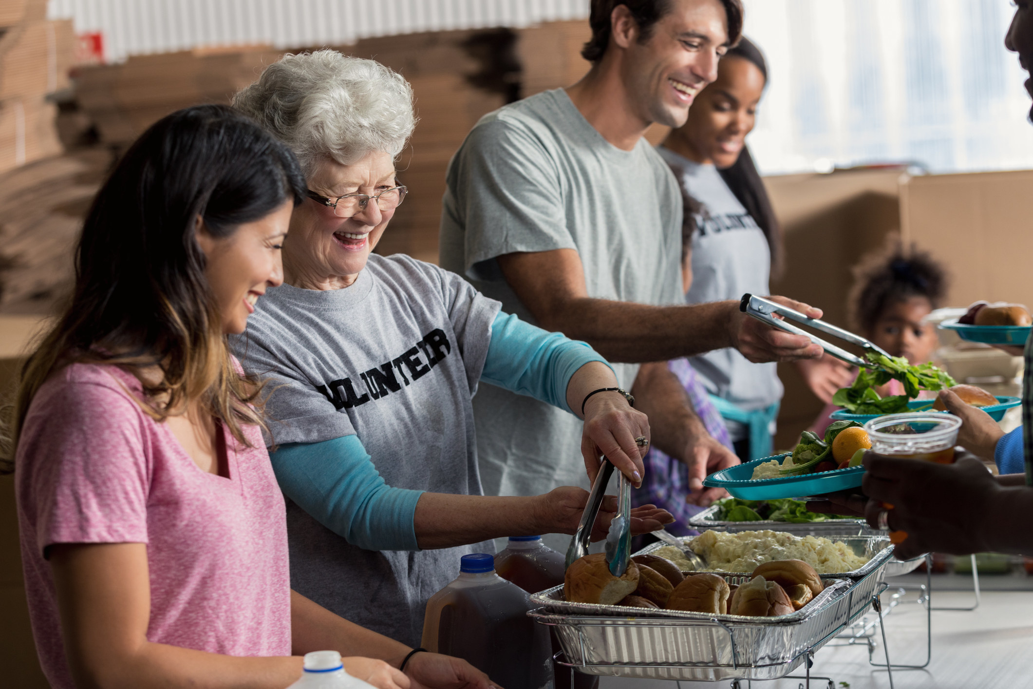Volunteers serve food at a shelter
