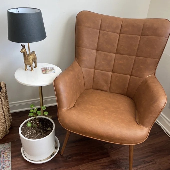 Reviewer image of chair next to an end table and plant