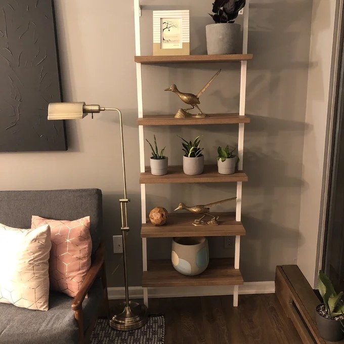 Reviewer image of bookshelf with accessories on it in a living room