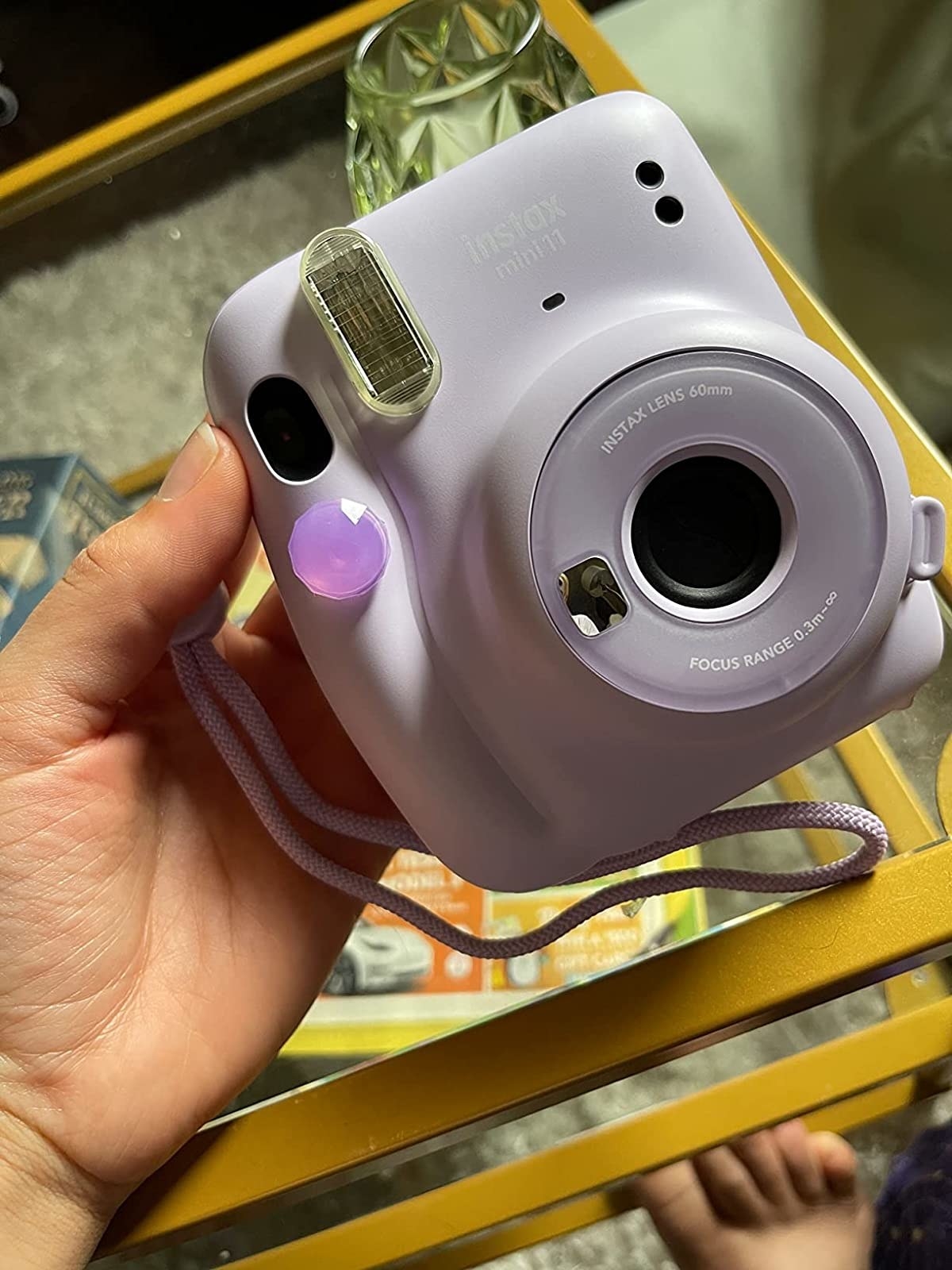 reviweer holding lavender Instax camera