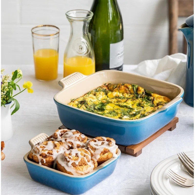 Glazed cinnamon roles in the smaller dish and a spinach casserole in the larger dish