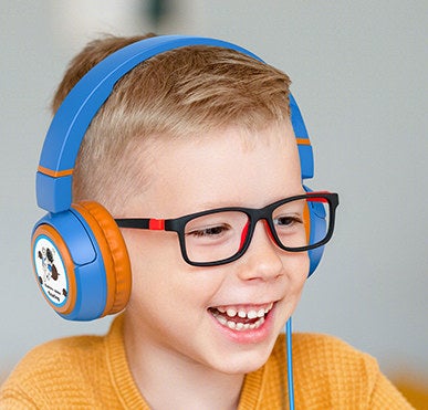 a kid smiling while wearing the headphones