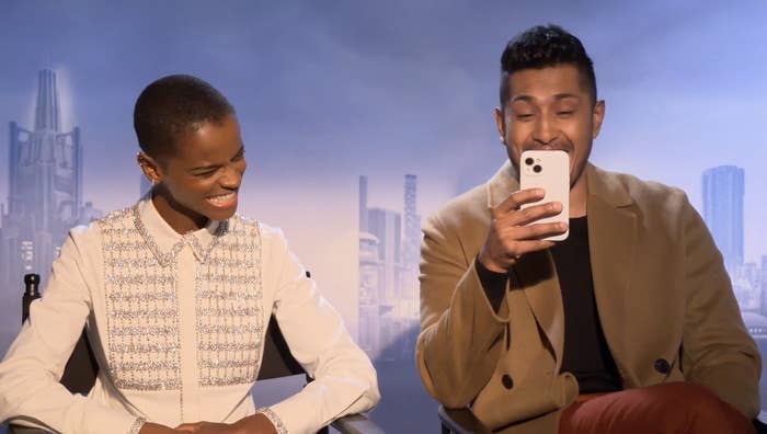 Letitia Wright and Tenoch Heurta laughing as Tenoch reads from his phone
