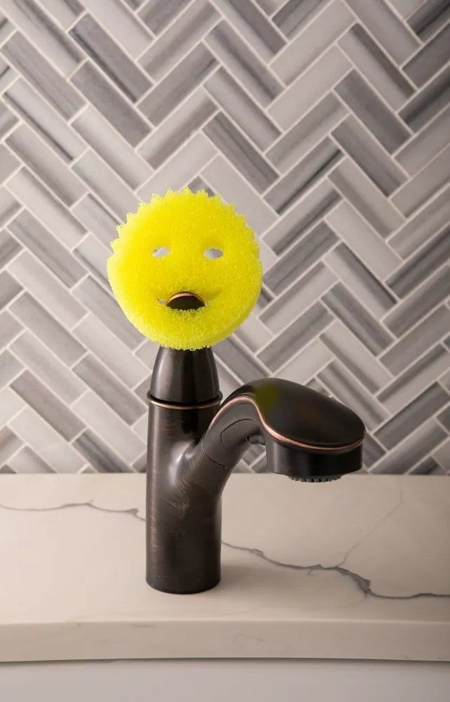 the scrub daddy sponge on a sink faucet