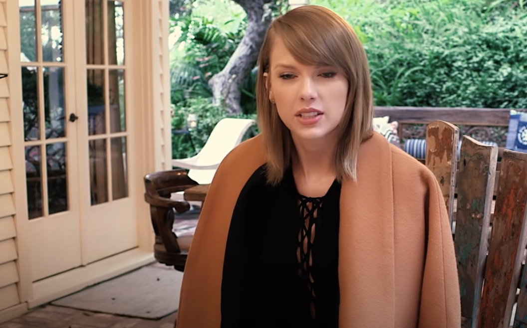 closeup of Taylor in the video, outside of her home