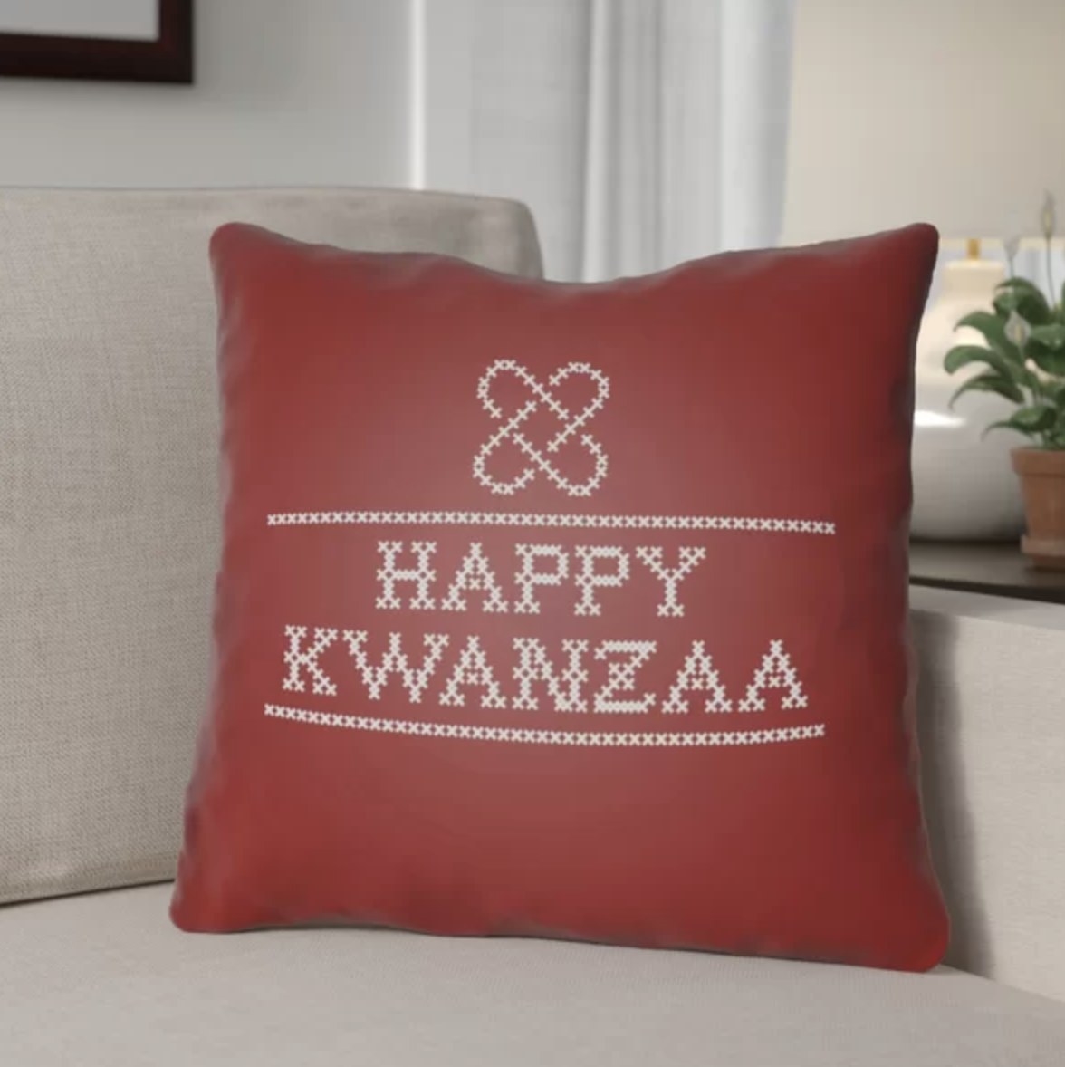 The red pillow says &quot;HAPPY KWANZAA&quot; in a sweater-like print