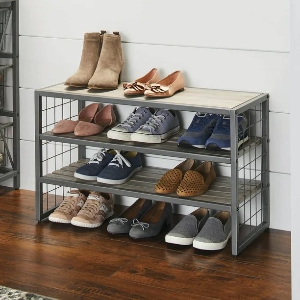 gray and wood three-tier shoe rack with shoes on it