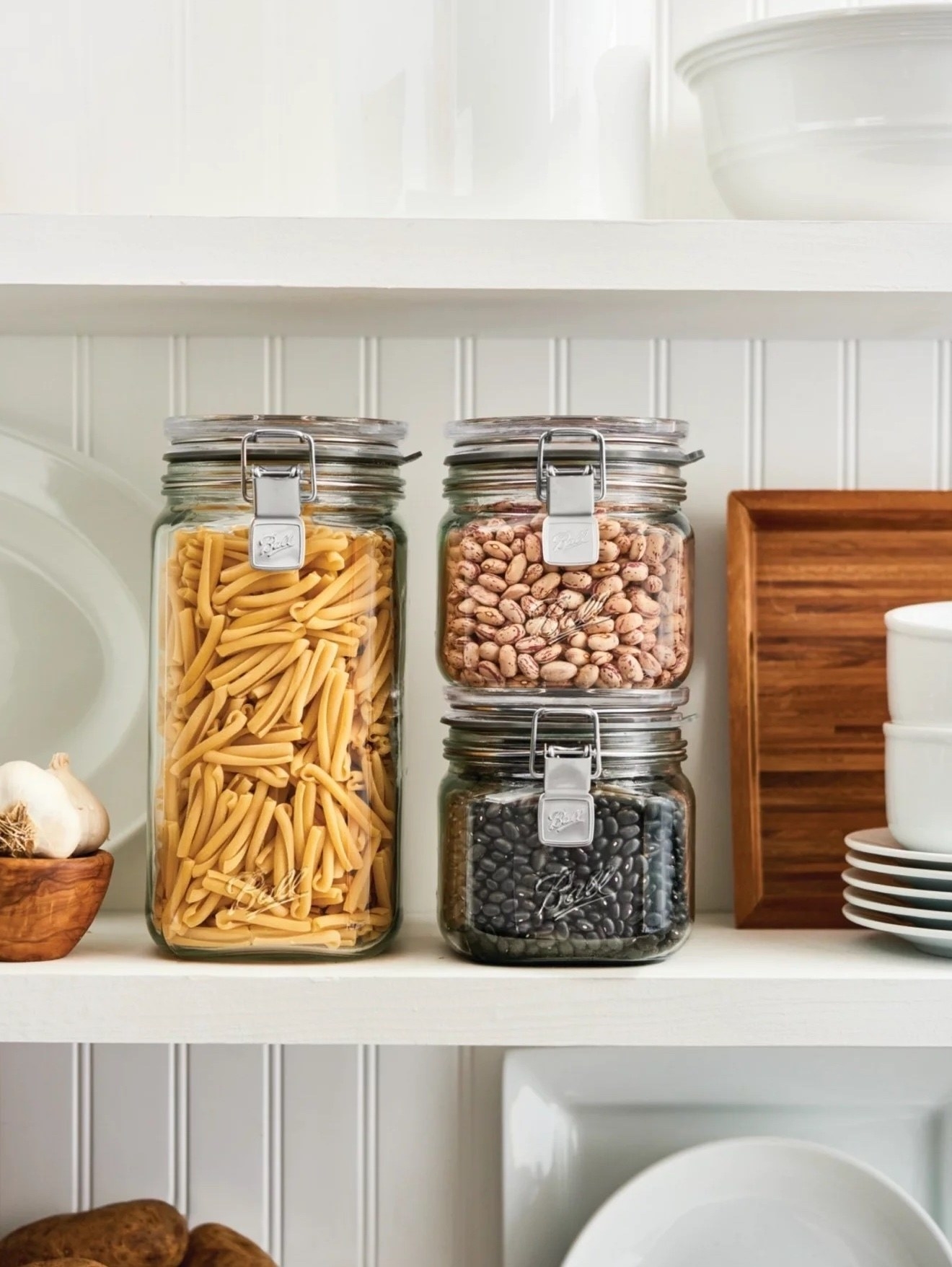three ball latch jars filled with dry goods on a shelf