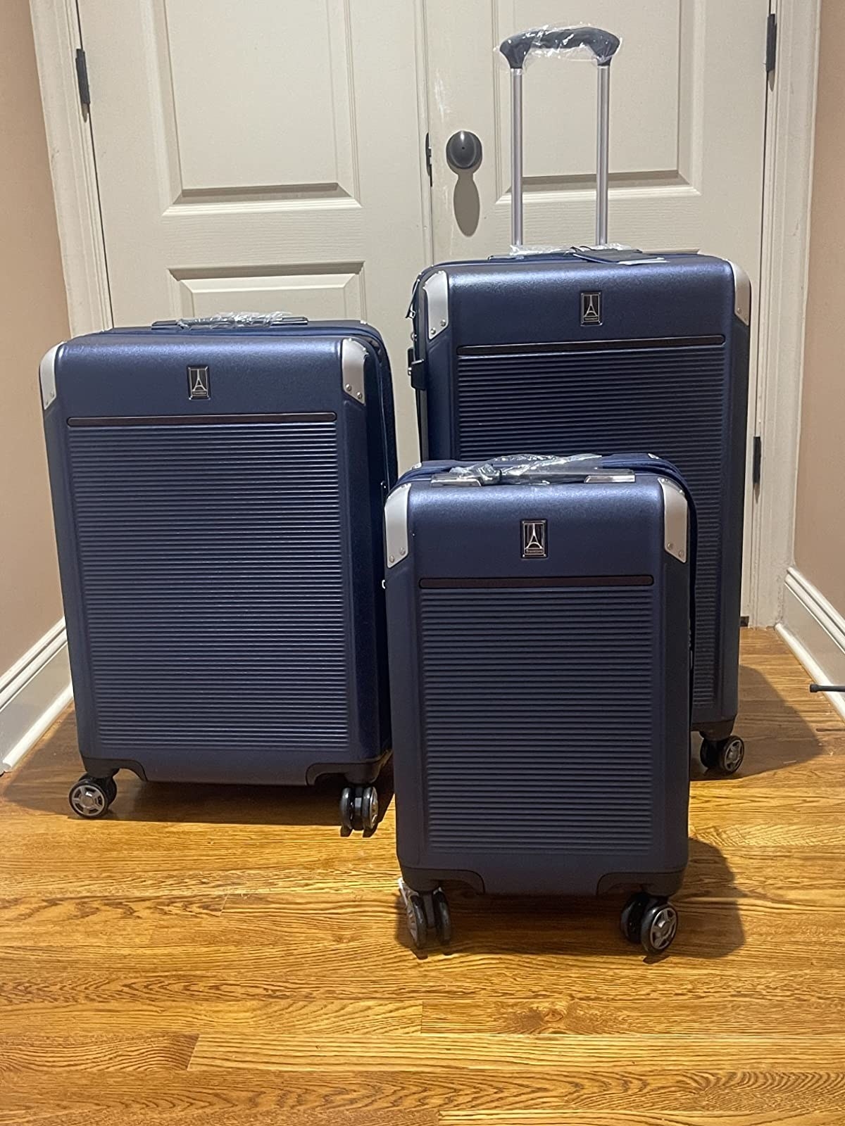 three blue travelrpo suitcases