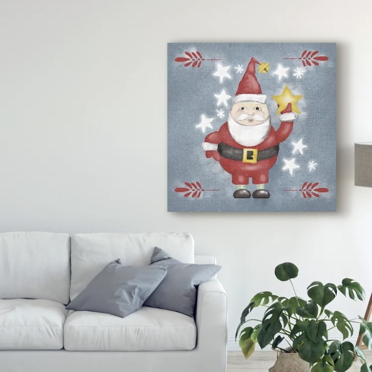 The Santa is holding a yellow star against a blueish grey background with red branches and white stars