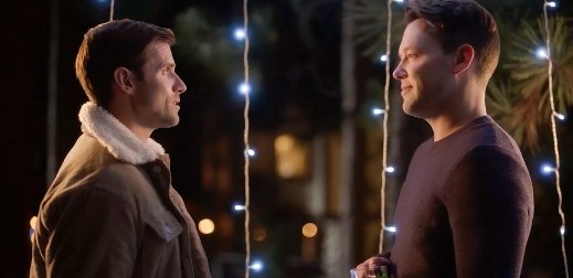 Taylor Frey and Kyle Dean Massey look at each other in front of fairy lights
