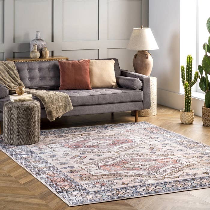 a blue and red southwestern washable rug in a living room