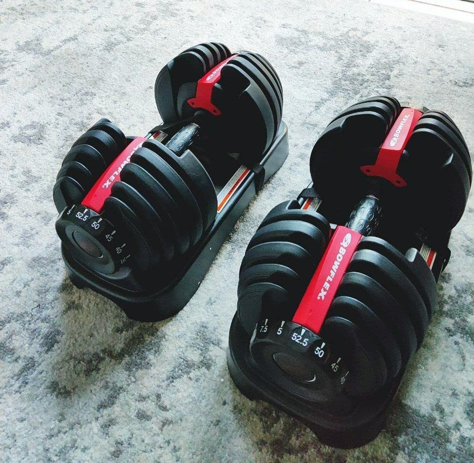 Reviewer&#x27;s set of dumbbells resting on carpet floor