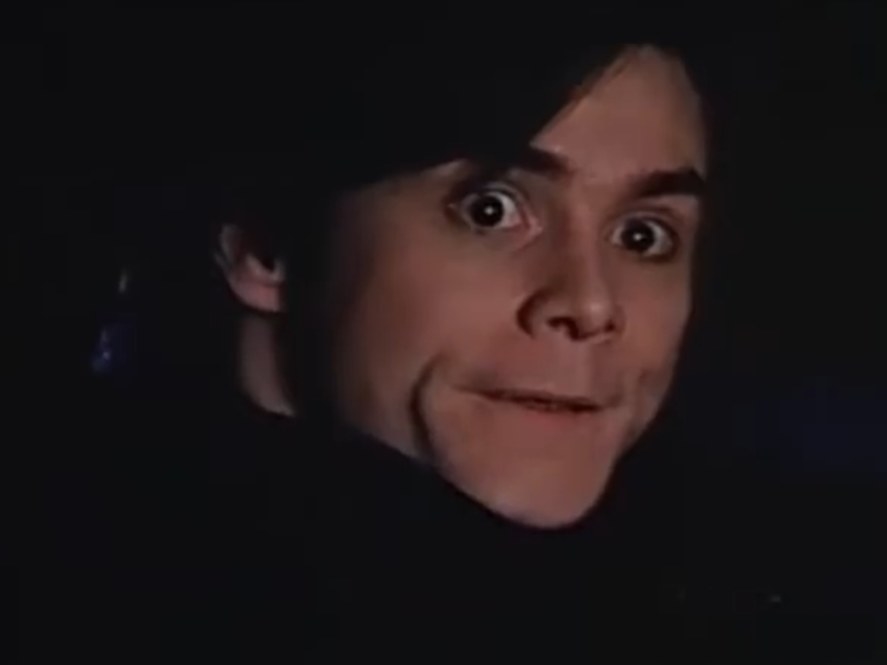 Jim Carrey as Death looking back at someone in the driver seat of a limo