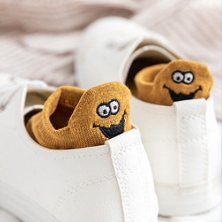 a pair of the dark yellow expressive socks inside a pair of shoes