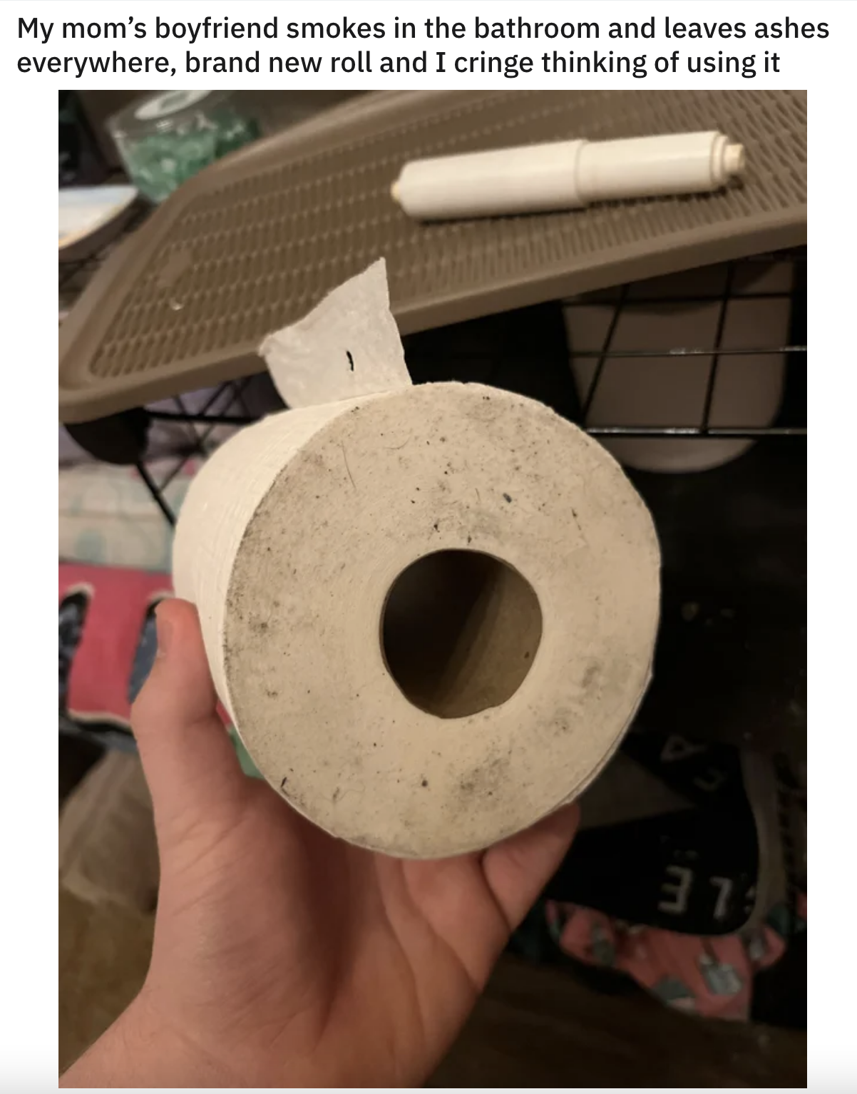 A roll of toilet paper with ash on the side of it