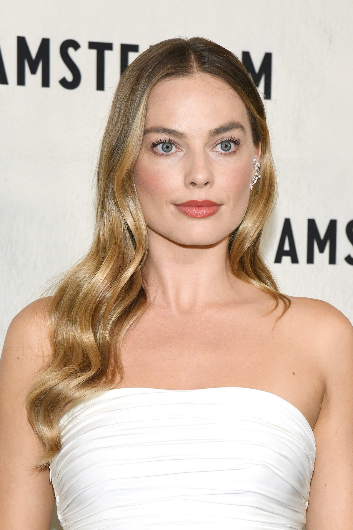 A closeup of Margot in a strapless outfit