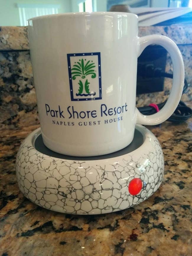 reviewer image of a mug sitting atop the ceramic mug warmer