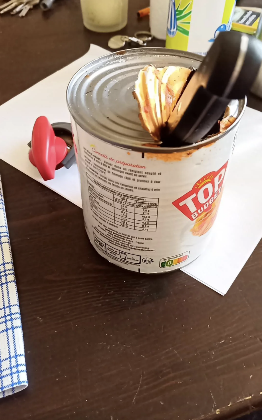 A can with the top hacked at, and a can opener right next to it, with the caption, &quot;How my boyfriend opened a can of ravioli at midnight&quot;
