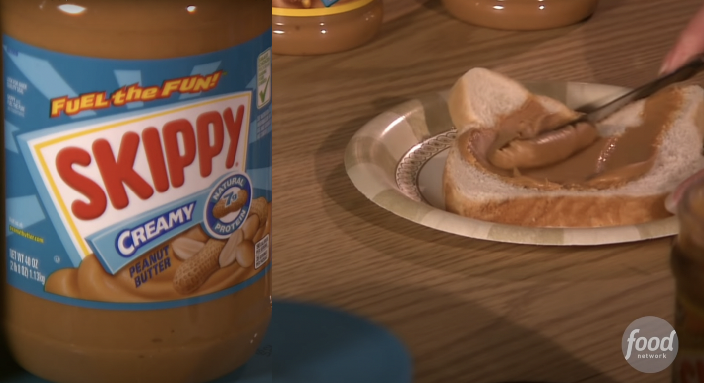 A close-up of someone spreading peanut butter on a sandwich