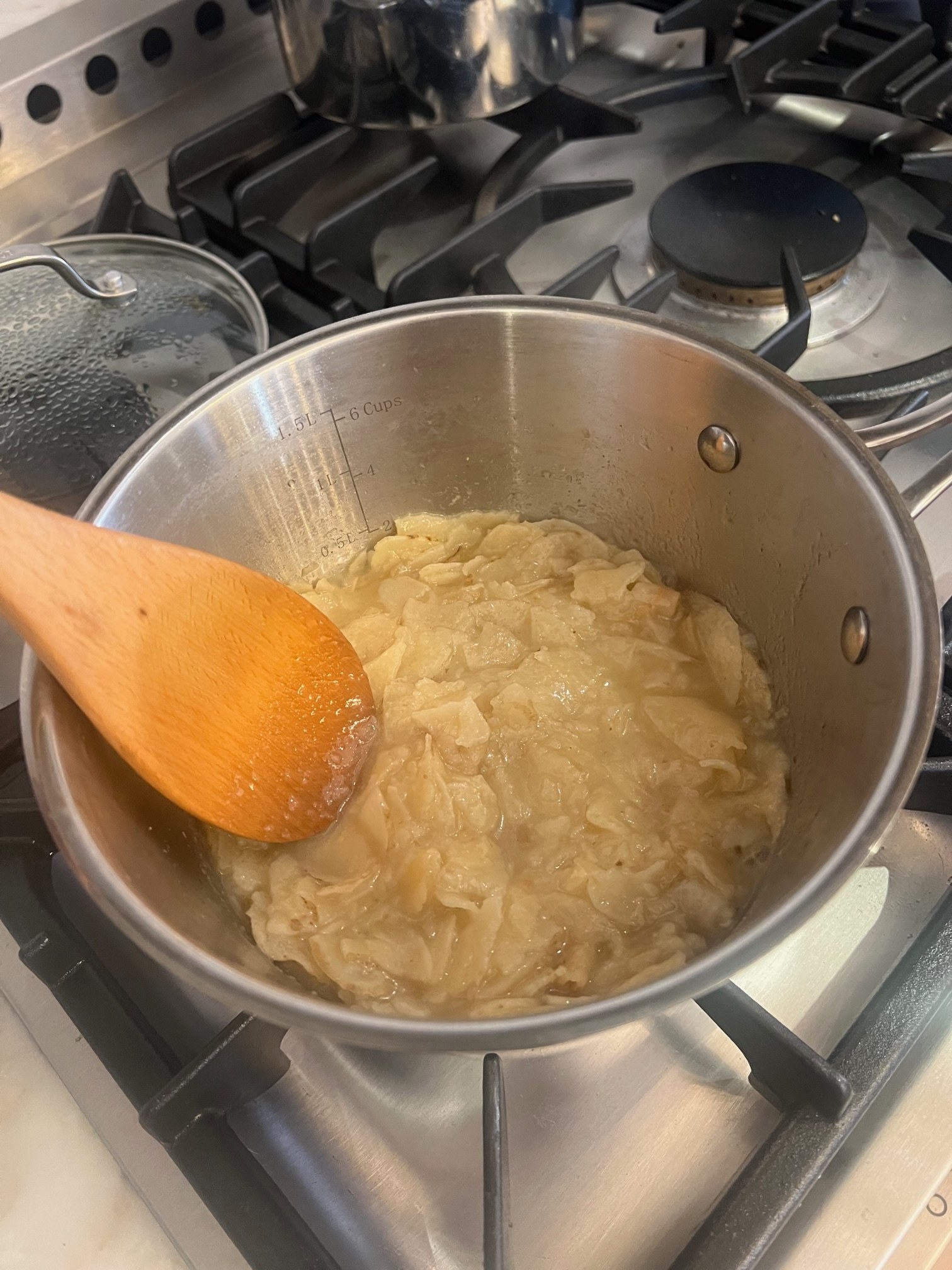 Potato chips in a pot of boiling water.