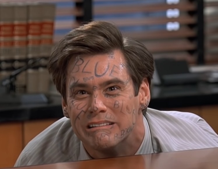 Jim Carrey as Fletcher with the word blue all over his face